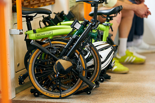 Custom Brompton bikes folded on London Overground train