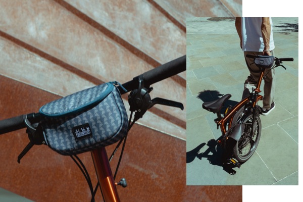 Close up image of the Brompton x Liberty zip pouch on Brompton handlebars